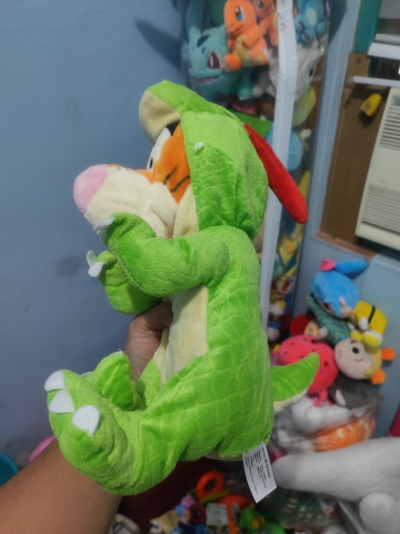 Disney Tigger Dinosaur Costume Plush Toy (Category: Plushies & Soft Toys) located in Iligan City. Submitted by sneakymagician (Listing ID 1464436615, Image 2). Description: - Adorable Tigger plush toy - Dressed in a cute dinosaur costume - Super soft and cuddly - Approximately 10-12 inches tall - Ideal for Winnie the Pooh fans - Great for display or playtime - A fun collectible item.