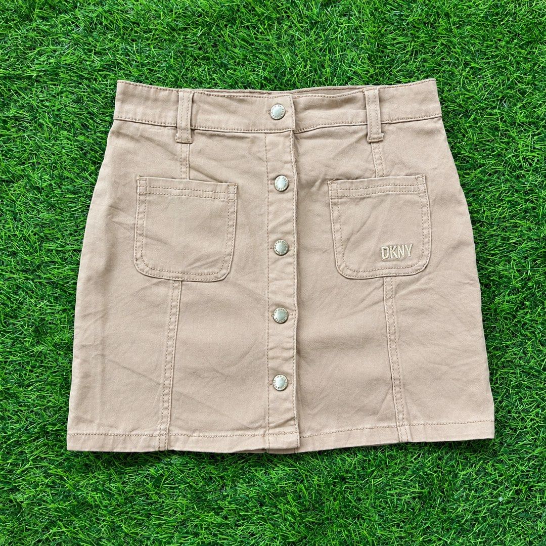 DKNY Tan Button Front Mini Skirt Size 8 (Category: Skirts) located in Cuyapo. Submitted by Ashtyn.Pre.Loved (Listing ID 1463196638, Image 1). Description: - Tan DKNY mini skirt - Button front closure - Two front pockets, one with DKNY logo - Made in Bangladesh - Size 8.