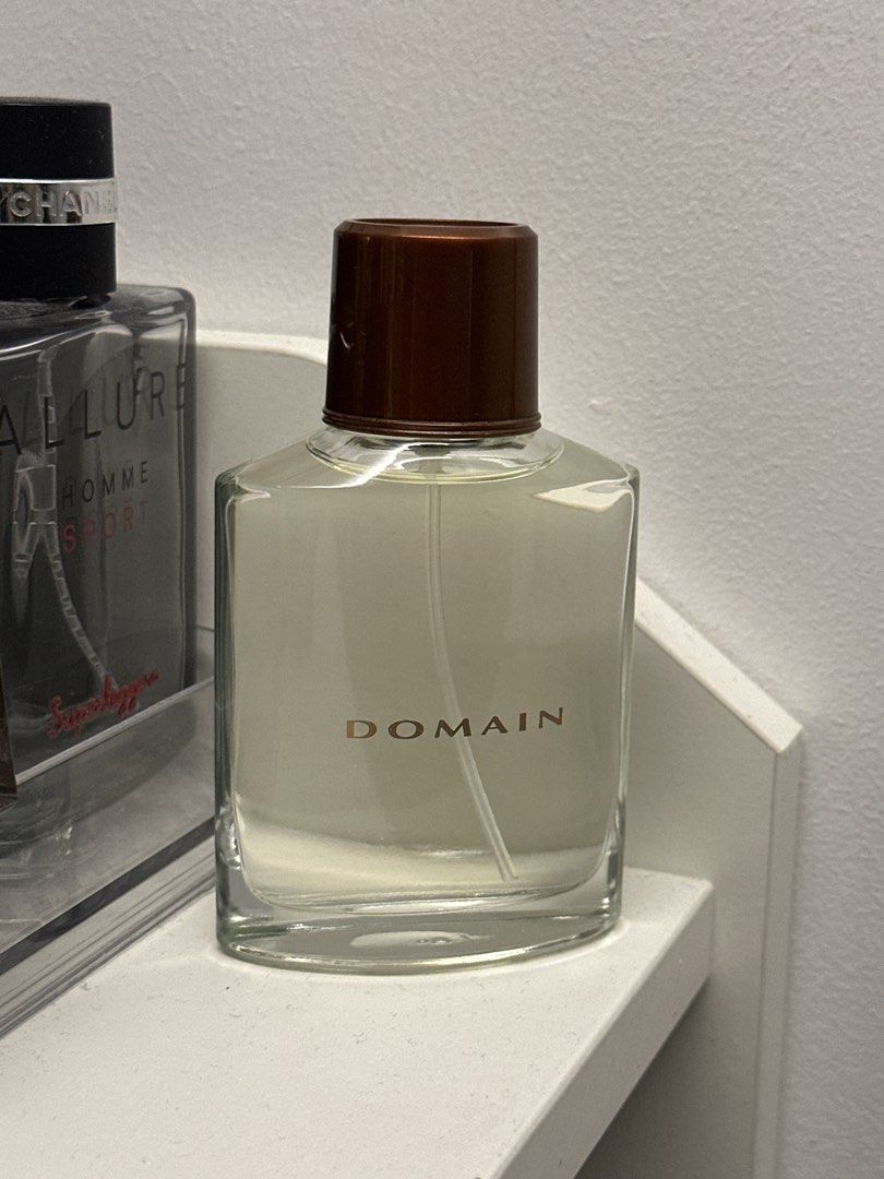 Domain Perfume for Men (Category: Fragrance & Deodorants) located in Manila. Submitted by grandtiger_60a8d7 (Listing ID 1464511303, Image 1). Description: - Domain perfume for men - Clear liquid in a square glass bottle - Gold 'DOMAIN' lettering on the front.