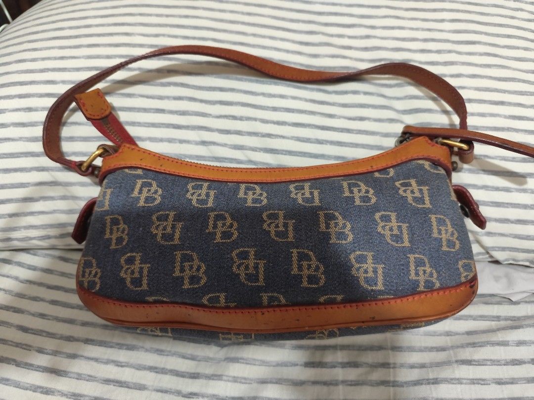 Dooney & Bourke Monogram Denim Shoulder Bag (Category: Luxury Bags & Wallets) located in Manila. Submitted by marriage031073advocate (Listing ID 1464411369, Image 2). Description: - Classic Dooney & Bourke shoulder bag - Signature DB monogram pattern on denim - Tan leather trim and strap - Zipper closure - Perfect everyday bag - Shows a little signs of wear on the leather trim but no other issues - Price Negotiable.