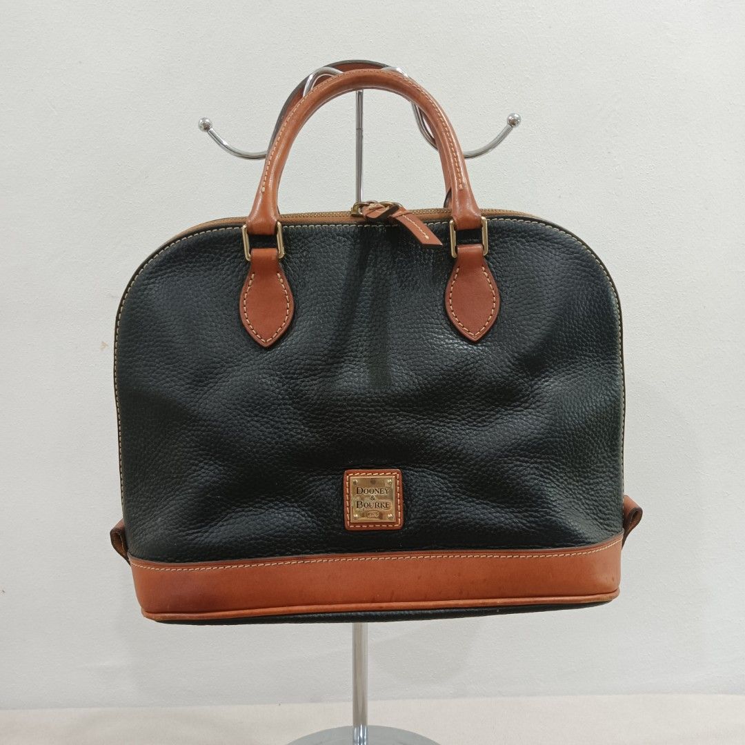 Dooney & Bourke Satchel Bag (Category: Luxury Bags & Wallets) located in Quezon City. Submitted by closetraiders.mnl (Listing ID 1464510166, Image 1). Description: Dooney & Bourke satchel bag - Tan leather trim and handles - Durable pebbled leather - Secure zipper closure.