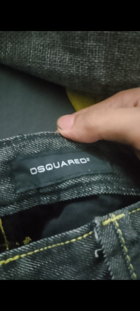 DSQUARED2 Denim Jeans (Category: Jeans) located in Manila. Submitted by calmturtle-a911 (Listing ID 1464466632, Image 3). Description: - Dark wash denim jeans - Distressed details for a rugged look - Eye-catching yellow stitching - Unique pocket designs - Large logo patch on the back - Relaxed fit, perfect for everyday casual wear.