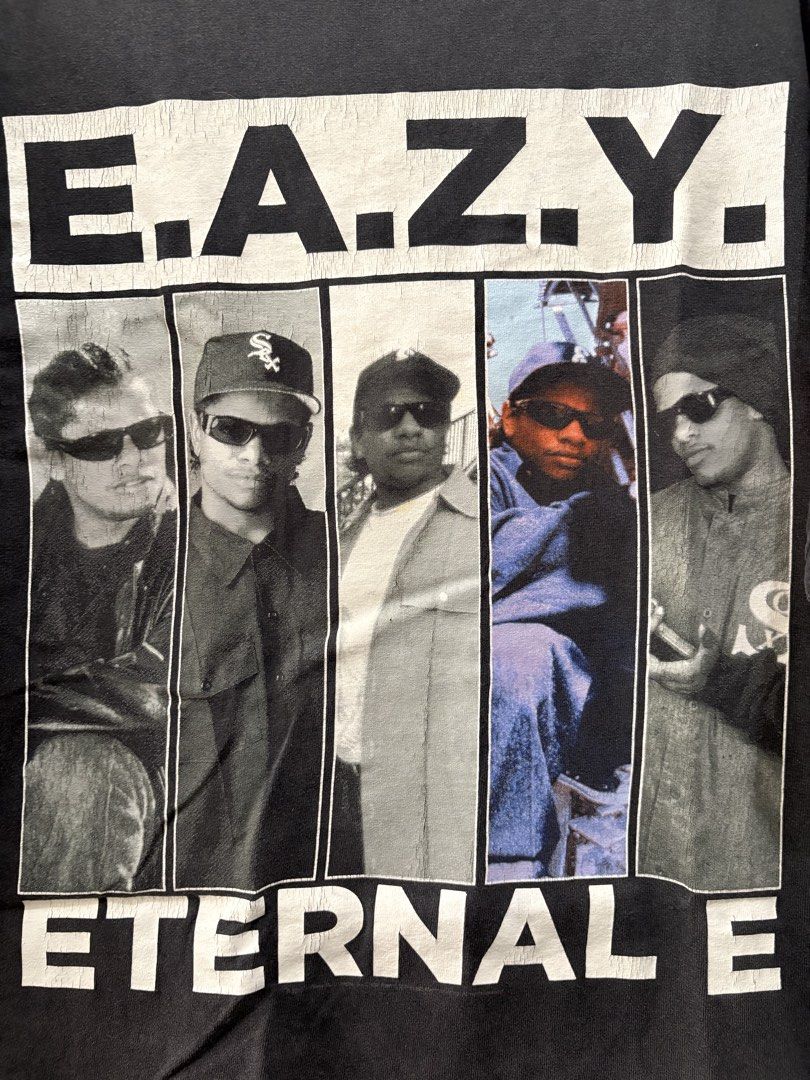 Eazy-E Eternal E T-Shirt (Category: Tshirts & Polo Shirts ) located in Manila. Submitted by dominicoab75406 (Listing ID 1464373366, Image 2). Description: - Classic black t-shirt - Features Eazy-E graphic print - Includes 'E.A.Z.Y.' and 'ETERNAL E' text - Depicts iconic Eazy-E and N.W.A. members - Ideal for hip-hop enthusiasts - A must-have addition to your collection.