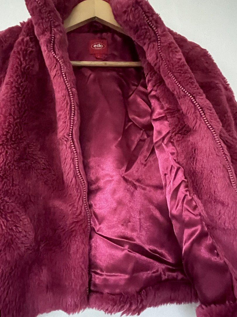 EDC by Esprit Faux Fur Jacket Large (Category: Babies & Kids Fashion) located in Quezon City. Submitted by witchinthecity (Listing ID 1464439869, Image 3). Description: - Super cozy faux fur jacket - Brand: EDC by Esprit - Size: L Kids - Features: Zip-up front, silky lining - Color: Deep berry / dark pink - stored in closet for a long time -shoulder to hem: 19.5 inches.