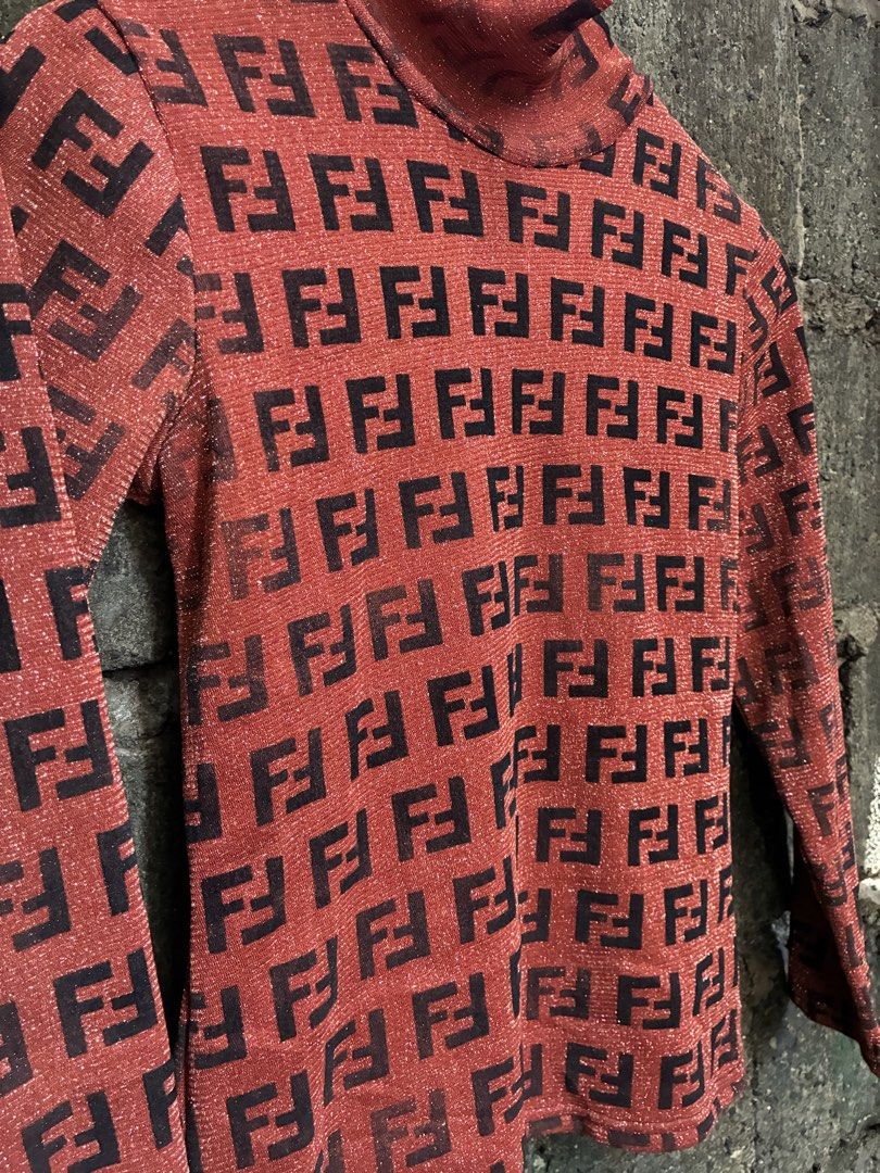 Fendi All Over FF Logo Turtleneck Top (Category: Longsleeves) located in Manila. Submitted by assortedgoodsv3 (Listing ID 1464461125, Image 2). Description: - Authentic Red Fendi Turtleneck Top - Iconic FF Logo Pattern All Over - Long Sleeves - High Neckline - Subtle Shimmering Fabric - Versatile Statement Piece: Pairs well with jeans or skirts.