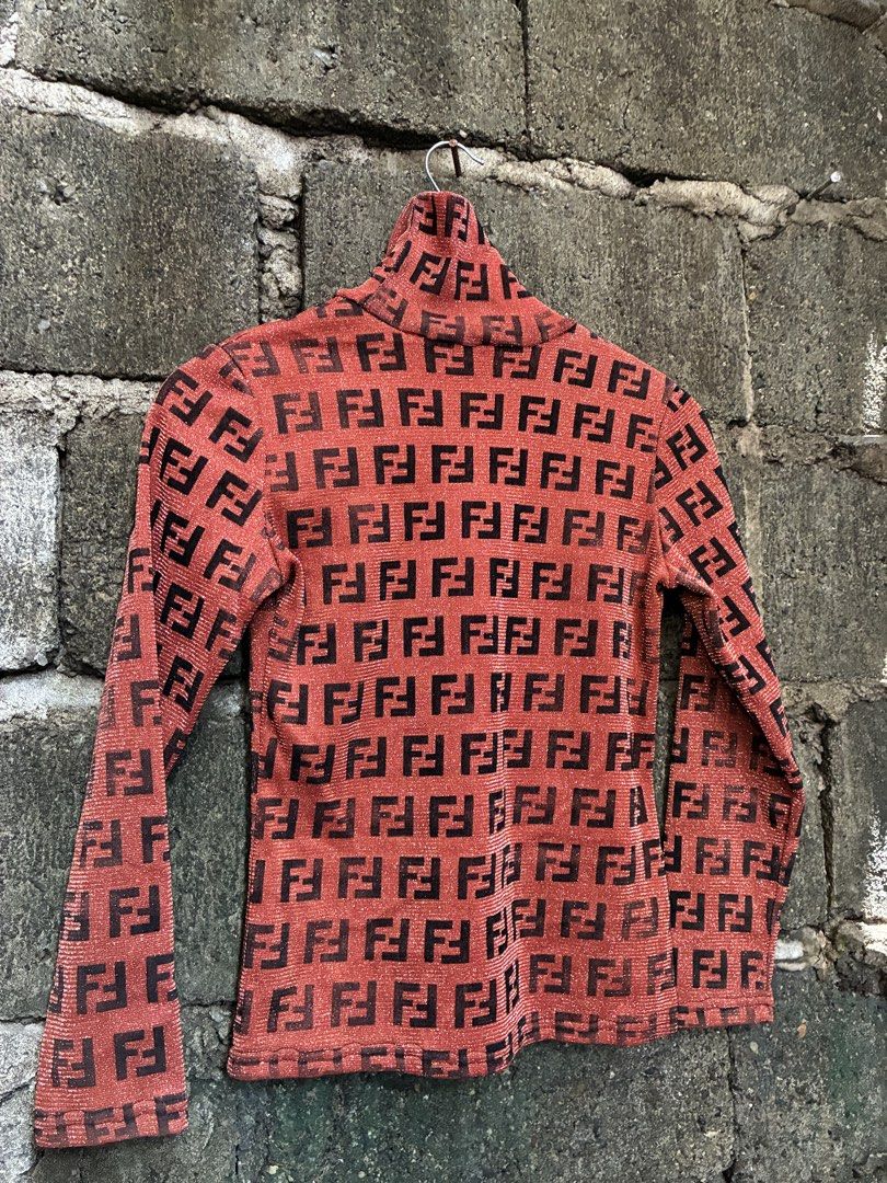 Fendi All Over FF Logo Turtleneck Top (Category: Longsleeves) located in Manila. Submitted by assortedgoodsv3 (Listing ID 1464461125, Image 3). Description: - Authentic Red Fendi Turtleneck Top - Iconic FF Logo Pattern All Over - Long Sleeves - High Neckline - Subtle Shimmering Fabric - Versatile Statement Piece: Pairs well with jeans or skirts.