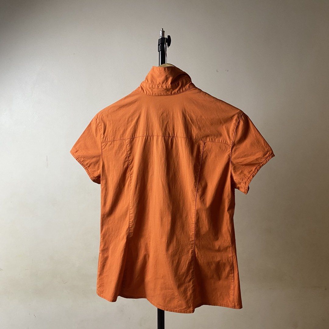 Fendi Jeans (Category: Luxury Apparel) located in Davao. Submitted by y2c0re (Listing ID 1464406662, Image 2). Description: Fendi Jeans Classic Button up polo shirt Size Medium/Small Womens - 18 width - 24 length Excellent condition Minor signs of use 9.5/10 - Fendi Jeans shirt in vibrant orange. - Short sleeves and classic collar for a timeless look. - Easy button-up front closure. - Expertly crafted in Italy. - Tagged as size 40 (Italian sizing