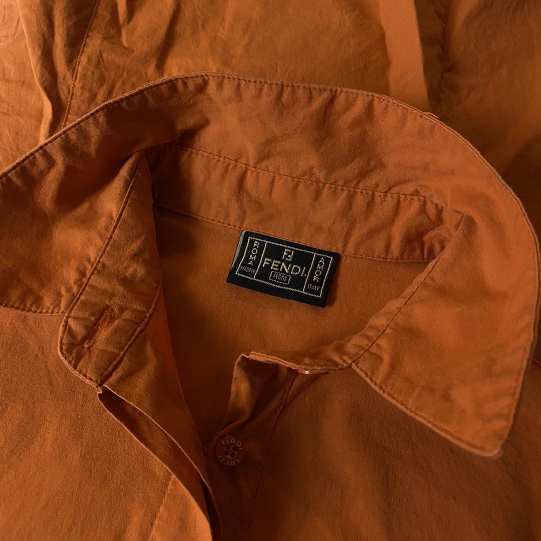 Fendi Jeans (Category: Luxury Apparel) located in Davao. Submitted by y2c0re (Listing ID 1464406662, Image 3). Description: Fendi Jeans Classic Button up polo shirt Size Medium/Small Womens - 18 width - 24 length Excellent condition Minor signs of use 9.5/10 - Fendi Jeans shirt in vibrant orange. - Short sleeves and classic collar for a timeless look. - Easy button-up front closure. - Expertly crafted in Italy. - Tagged as size 40 (Italian sizing