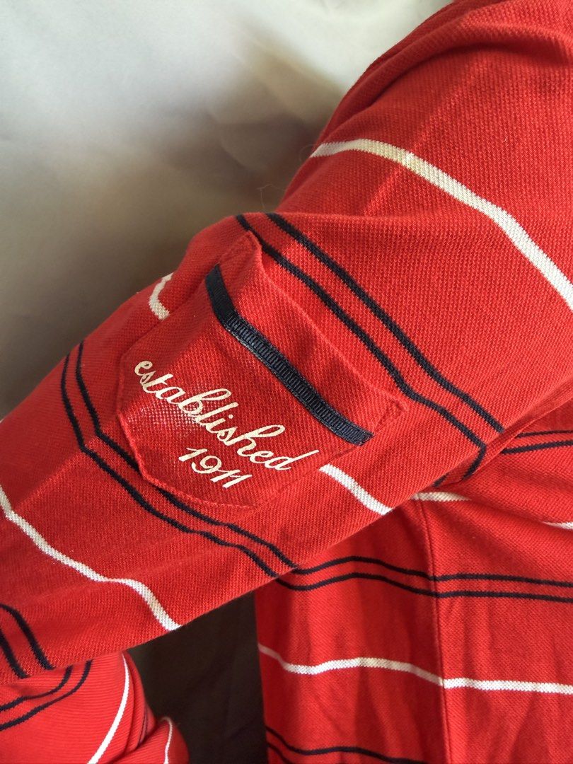 Fila Red Striped Quarter Zip Long Sleeve Top (Category: Longsleeves) located in La Trinidad. Submitted by rare_closet_finds (Listing ID 1464354932, Image 2). Description: - Classic red Fila long sleeve top -armpit to armpit 18” -length 22” - Features stylish white and navy stripes - Convenient quarter zip neckline - Small embroidered Fila logo on the chest - Unique pocket detail on the left sleeve with 'established 1911' embroidery - Ideal for ev