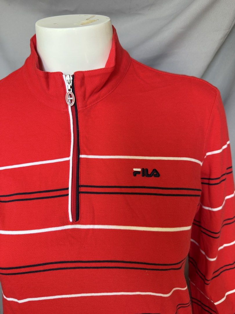 Fila Red Striped Quarter Zip Long Sleeve Top (Category: Longsleeves) located in La Trinidad. Submitted by rare_closet_finds (Listing ID 1464354932, Image 3). Description: - Classic red Fila long sleeve top -armpit to armpit 18” -length 22” - Features stylish white and navy stripes - Convenient quarter zip neckline - Small embroidered Fila logo on the chest - Unique pocket detail on the left sleeve with 'established 1911' embroidery - Ideal for ev