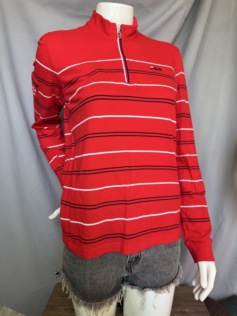 Fila Red Striped Quarter Zip Long Sleeve Top (Category: Longsleeves) located in La Trinidad. Submitted by rare_closet_finds (Listing ID 1464354932, Image 1). Description: - Classic red Fila long sleeve top -armpit to armpit 18” -length 22” - Features stylish white and navy stripes - Convenient quarter zip neckline - Small embroidered Fila logo on the chest - Unique pocket detail on the left sleeve with 'established 1911' embroidery - Ideal for ev