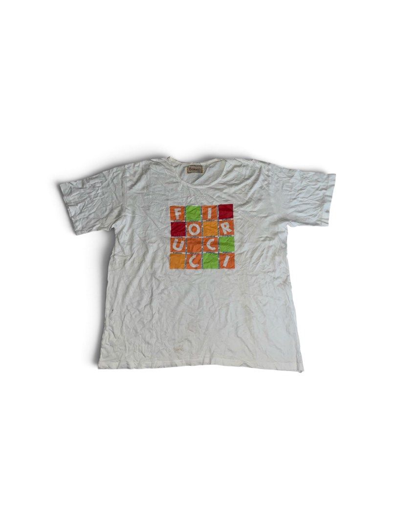 Fiorucci White Graphic T-Shirt (Category: Shirts) located in Nabua. Submitted by lastthrift2.0 (Listing ID 1464515090, Image 1). Description: Dimes•22x25 Single stitch - White Fiorucci t-shirt - Colorful graphic print with letters in squares on the front - Short sleeves - Crew neck - Made of comfortable cotton - Ideal for casual wear.