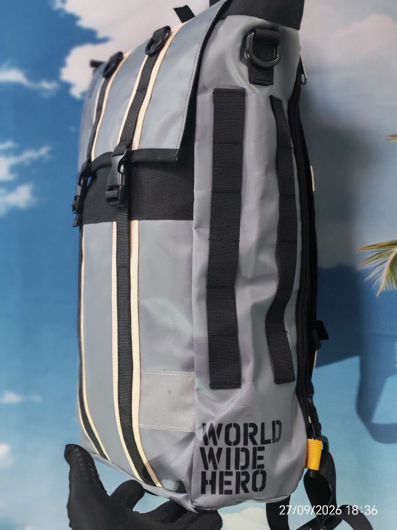 Fire first (Category: Backpacks) located in Shah Alam. Submitted by begbundle17_bb17 (Listing ID 1464514064, Image 3). Description: - Grey backpack with black accents - Multiple straps and buckles for secure closure - Side pocket with zipper - Padded straps and back for comfort - 'WORLD WIDE HERO' text detail - Perfect for everyday use or travel.