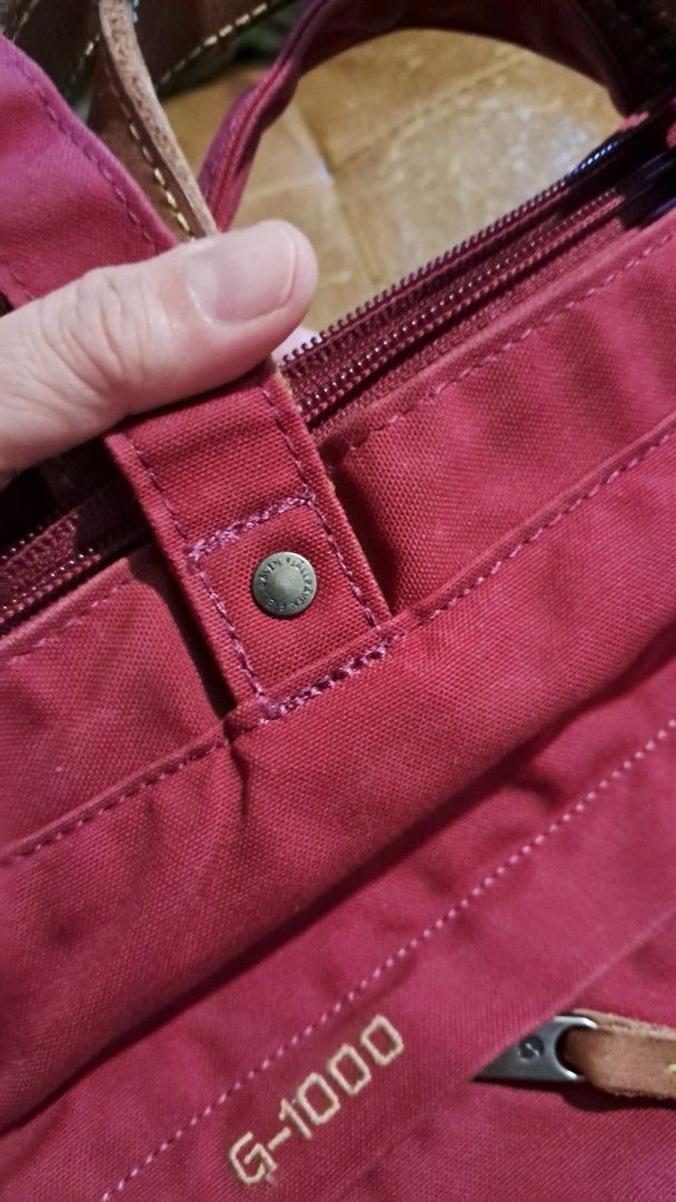 Fjallraven G-1000 Tote Bag (Category: Tote Bags) located in Cavite. Submitted by naning049 (Listing ID 1464426158, Image 2). Description: - Fjallraven tote bag in a rich deep berry color. - Crafted from durable G-1000 material. - Features stylish leather accents on the handles. - Convenient front zippered pocket for quick access. - Main compartment zips securely closed. - Perfect everyday size. needs a bit of cleaning PWEDE BACK PACK PWEDE TOTE B