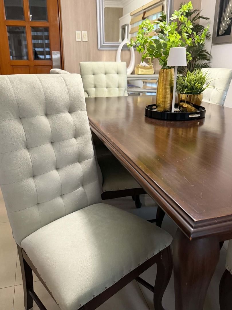 FOR SALE — 8-SEATER DINING SET (Category: Tables & Sets) located in Santa Rosa. Submitted by jen.cantila (Listing ID 1464548650, Image 2). Description: FOR SALE — 8-SEATER DINING SET Elegant and spacious 8-seater dining set, featuring a rich dark-wood rectangular dining table paired with 8 comfortable cream upholstered chairs. The tufted backrests and nailhead detailing give the chairs a refined classic look, while the warm wood finish makes the 