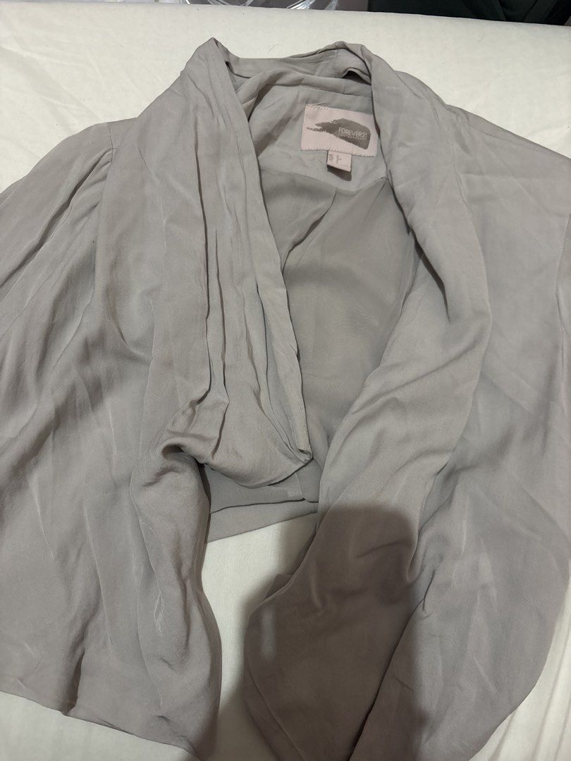 Forever 21 Contemporary Grey Drape Front Jacket (Category: Coats, Jackets and Outerwear) located in Munoz. Submitted by meowmeowmeowmeowz (Listing ID 1464477236, Image 1). Description: - Grey drape front jacket - From Forever 21 Contemporary - Lightweight material, ideal for layering - Includes a tie belt - Size: S - Made in Vietnam.