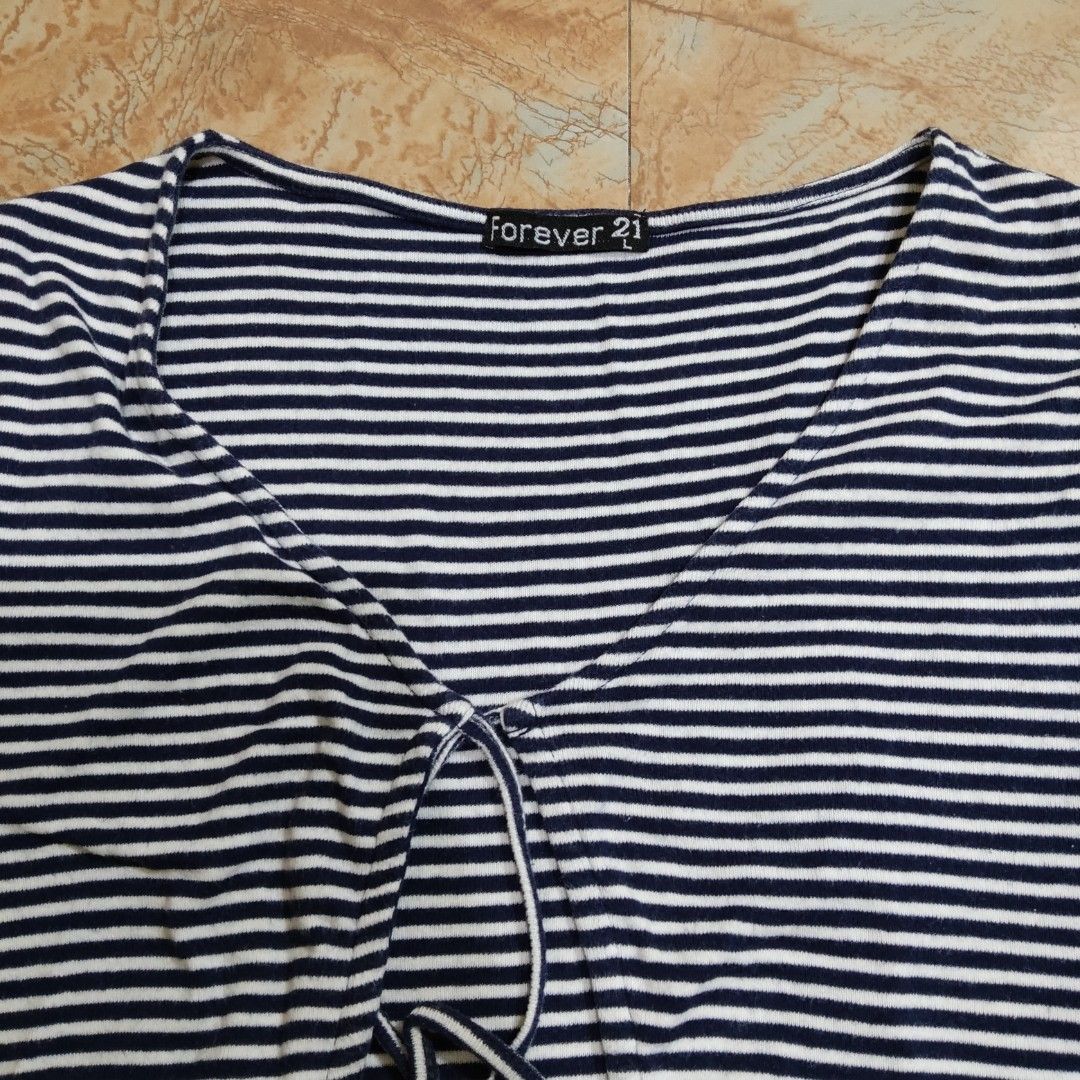 Forever 21 Striped Wrap Top (Category: Others Tops) located in Valenzuela. Submitted by ecasprelvd (Listing ID 1464450584, Image 3). Description: Navy & white striped top Wrap-style front with tie detail Short sleeves Forever 21, tagged large but fits small Valenzuela Delivery: Lalamove / J&T.