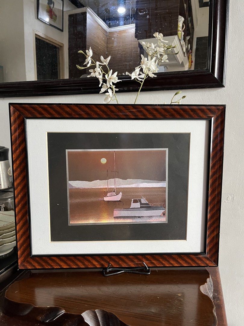 Framed Artwork: Boats at Sunset (Category: Frames & Pictures) located in Taguig. Submitted by minmin_parker (Listing ID 1464380344, Image 2). Description: - Captivating framed artwork featuring two boats on the water. - Serene sunset scene adds a warm ambiance. - Elegant dark wood grain finish frame. - Ideal for enhancing your home decor. - Comes ready to hang or can be displayed on a stand..