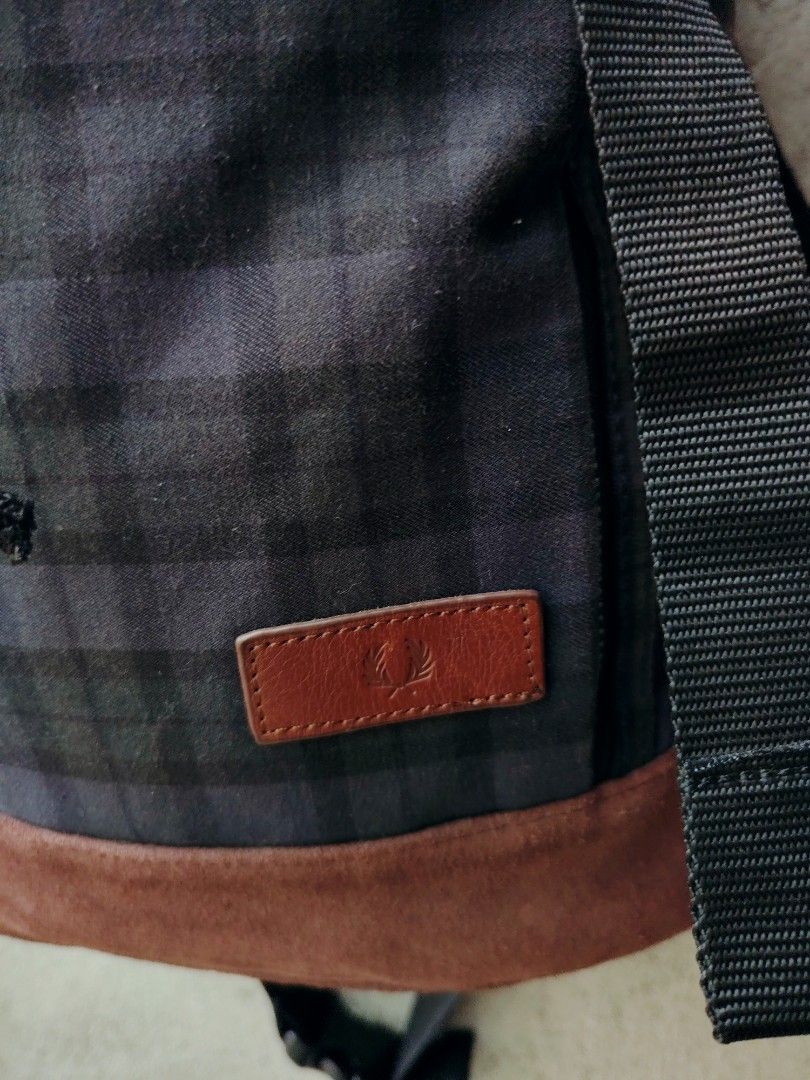 FRED PERRY BACK PLAID BACKPACK🎒 (Category: Backpacks) located in Bislig. Submitted by tuazons21 (Listing ID 1464509221, Image 2). Description: FRED PERRY BACK PLAID BACKPACK🎒 DIMENSIONS 16.5-17×23 CR 9.7/10 SLIGHTLY USED DETAILS POSTED⤵️ 💸📩 📌This is an authentic Fred Perry rucksack featuring a dark plaid pattern, dual-buckle top closure, a front zippered compartment, and a contrasting brown base panel.If you are looking for similar styles, c