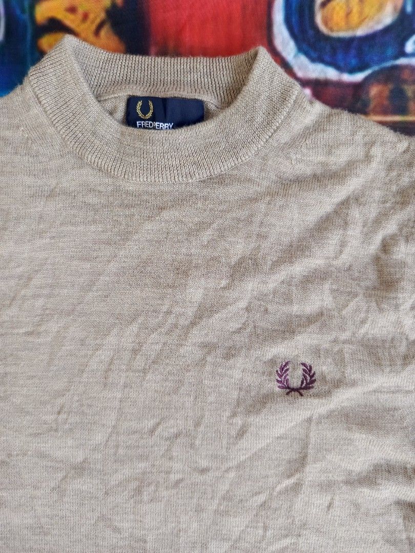 Fred Perry Mock Neck Sweater - Beige (Category: Coats, Jackets and Outerwear) located in City of Isabela. Submitted by warmbird.d06e6f (Listing ID 1464493525, Image 2). Description: - Classic beige mock neck sweater from Fred Perry. - Features the iconic embroidered laurel wreath logo on the chest. - Ribbed collar, cuffs, and hem with subtle stripe detailing. - Made from a warm and comfortable wool blend. - Perfect for layering or wearing solo. d
