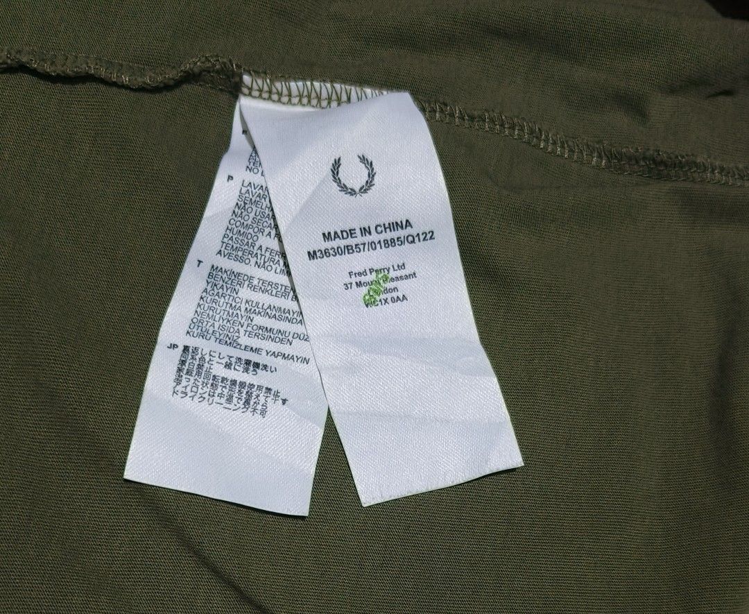 Fred Perry Olive Green Graphic T-Shirt (Category: Luxury Apparel) located in Manila. Submitted by tonsky_thrift (Listing ID 1464376031, Image 3). Description: ‎📌 Size: medium ‎📌 Dimes: 19.5 x 27.5 ‎📌 Colorate: 9.8/10 ‎📌 excellent condition ‎📌 Issue:none ‎ ‎ -Olive green Fred Perry T-shirt - Features a cool black graphic print on the front - 'Original Since 1952' text printed on the sleeve - Made in China - Size: Medium (M) - Ideal for casual
