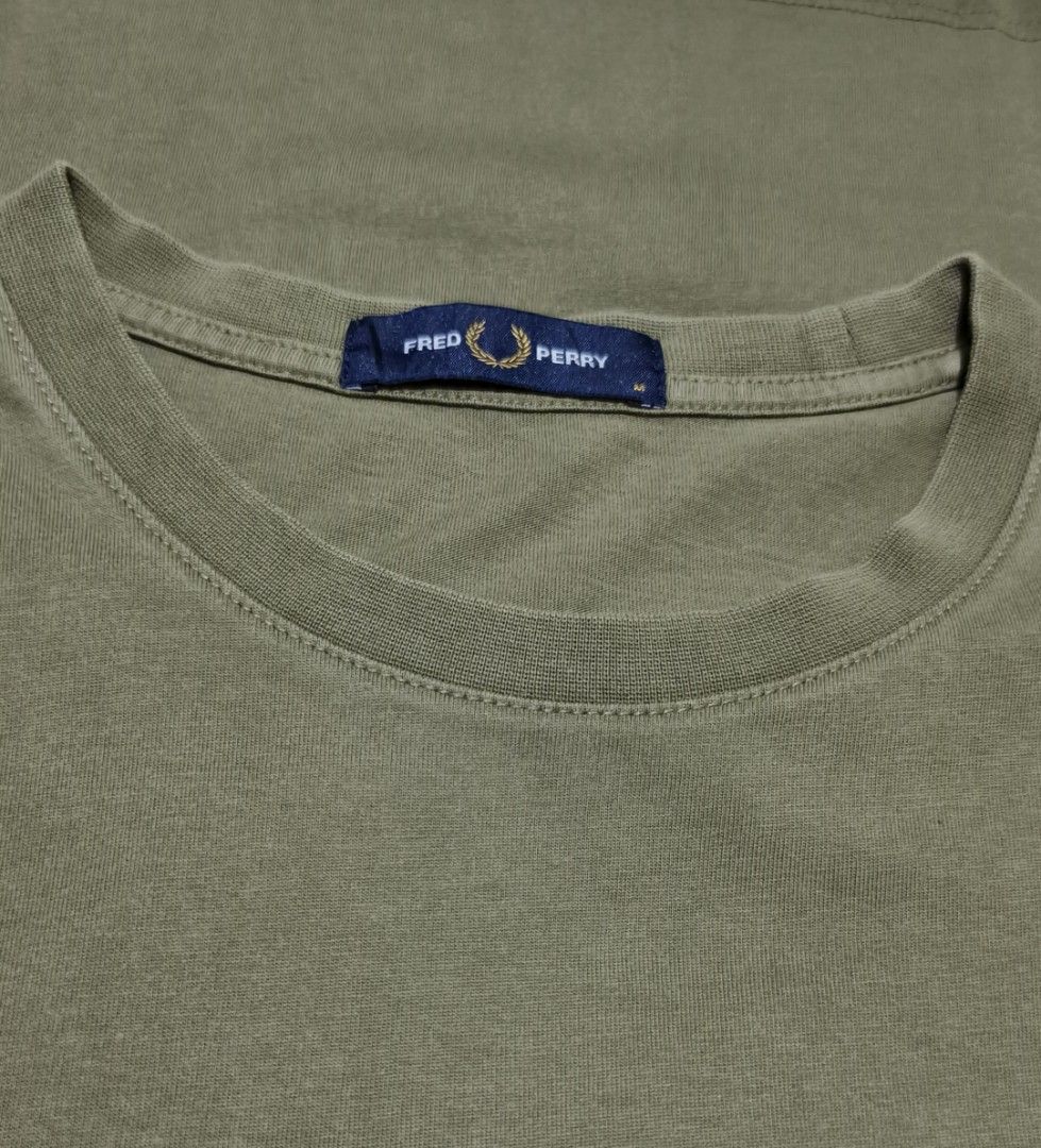 Fred Perry Olive Green Graphic T-Shirt (Category: Luxury Apparel) located in Manila. Submitted by tonsky_thrift (Listing ID 1464376031, Image 2). Description: ‎📌 Size: medium ‎📌 Dimes: 19.5 x 27.5 ‎📌 Colorate: 9.8/10 ‎📌 excellent condition ‎📌 Issue:none ‎ ‎ -Olive green Fred Perry T-shirt - Features a cool black graphic print on the front - 'Original Since 1952' text printed on the sleeve - Made in China - Size: Medium (M) - Ideal for casual