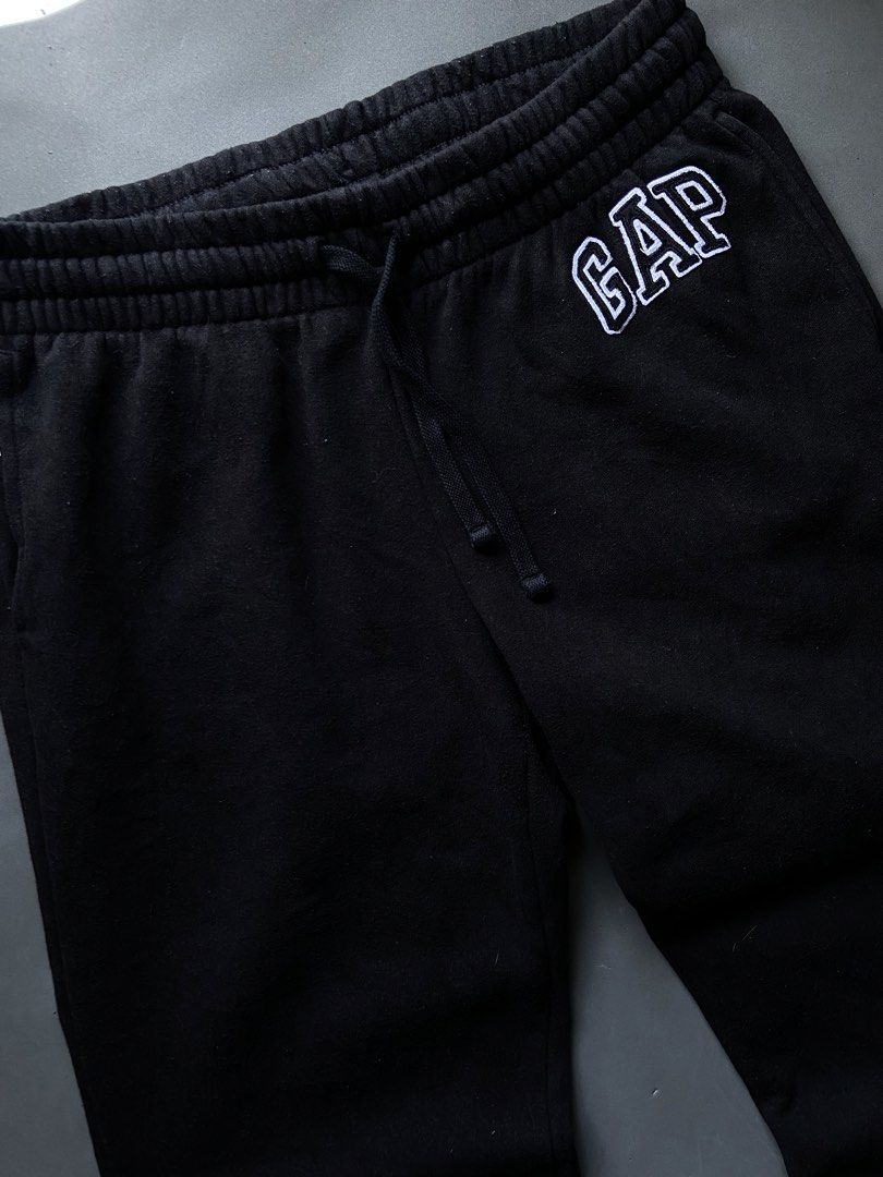 GAP Black Sweatpants Joggers with Logo (Category: Joggers) located in Manila. Submitted by seccccction80 (Listing ID 1464430494, Image 2). Description: - Black sweatpants from GAP - Features classic embroidered GAP logo on left thigh - Elastic waistband with adjustable drawstring for a comfortable fit - Made from soft, cozy material - Ideal for lounging or casual everyday wear.