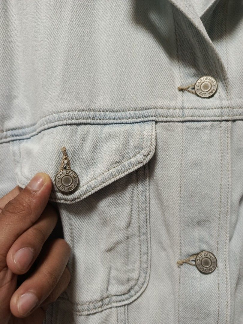Gap Denim Jacket XL Light Wash Short Sleeve (Category: Coats, Jackets and Outerwear) located in Cabatuan. Submitted by penthegreat (Listing ID 1464568150, Image 2). Description: 22.5 width & 24.5 length 9.5/10 condition - Light wash Gap denim jacket - Short sleeves with rolled cuffs - Classic button-up front - Two chest pockets - Made of 100% cotton - Versatile for layering or wearing alone - Easy to style with any outfit.