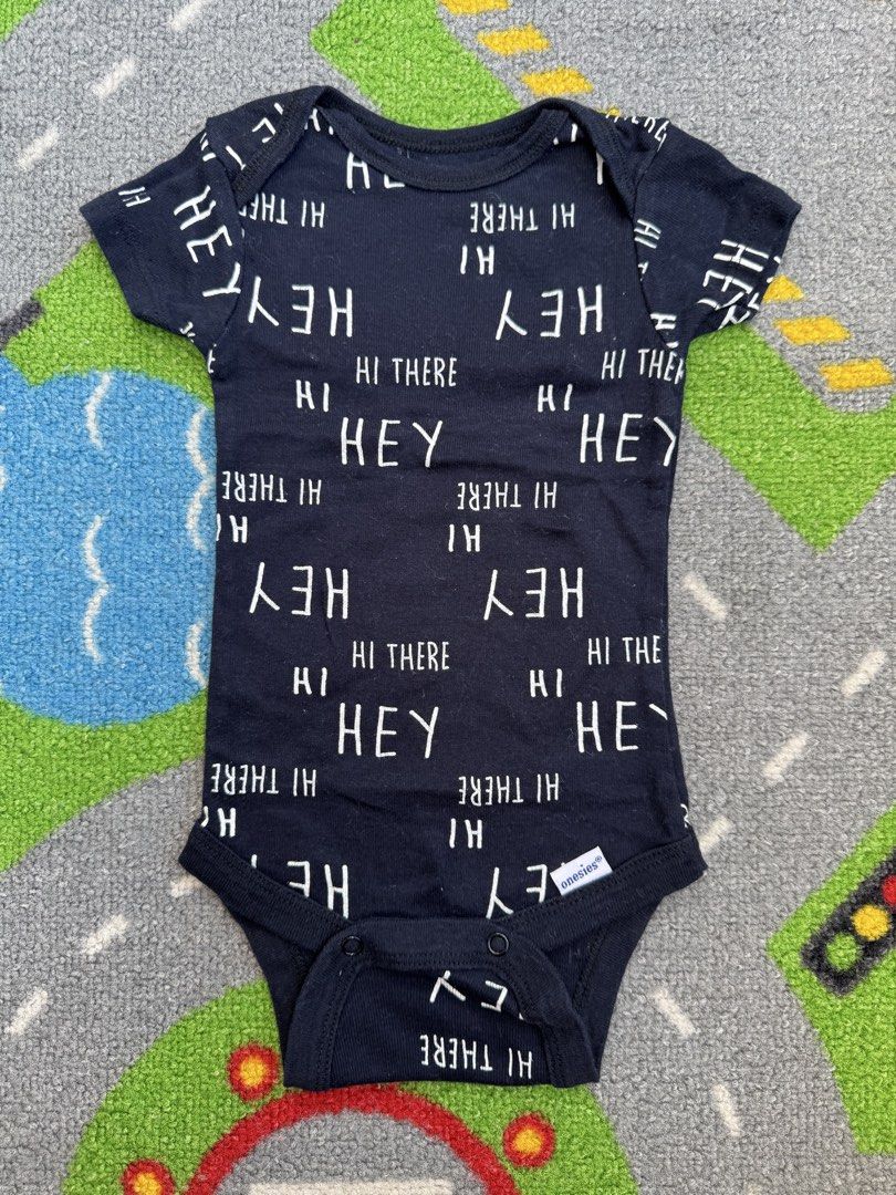 Gerber Onesie Bodysuit (Category: Babies & Kids Fashion) located in Rizal. Submitted by preloovved (Listing ID 1464415121, Image 1). Description: Cute black baby onesie with 'Hey There' and 'Hey' print. Short sleeves, snap closure. Brand: Onesies. Perfect for daily wear or gifting. Preloved, 0-3mos Meet-up only in GB1 San Mateo, Rizal Shipping fee c/o buyer. Tres Marias or J&T express Payment to be sent to me via BPI/BDO/GCASH only. 😁 C-2.