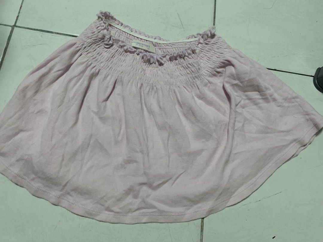 Gingersnaps Tiny Pink Smocked Skirt Size 24 Months (Category: Babies & Kids Fashion) located in Malabon City. Submitted by vewonica (Listing ID 1464417026, Image 1). Description: - Cute pink skirt from Gingersnaps Tiny - Features a smocked waistband with ruffles - Made from soft and flowy fabric - Versatile for everyday wear or special occasions - Easy to pair with various tops.