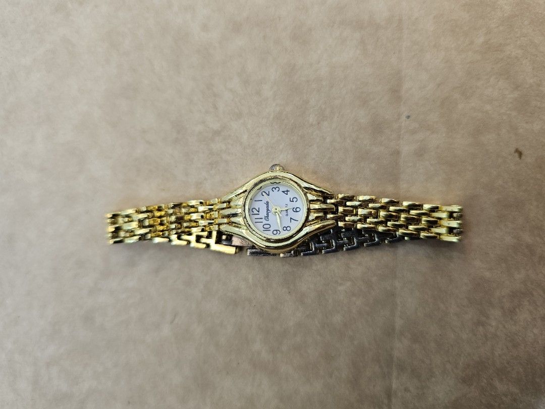 Gold Tone Analog Watch (Category: Women's Watches) located in Manila. Submitted by john.tulalian (Listing ID 1464407409, Image 1). Description: - Gold tone analog watch - White face with gold hour markers - Classic link bracelet - Clasp closure - Simple and timeless design - Ideal for everyday wear -Negotiable -Price+Sf.