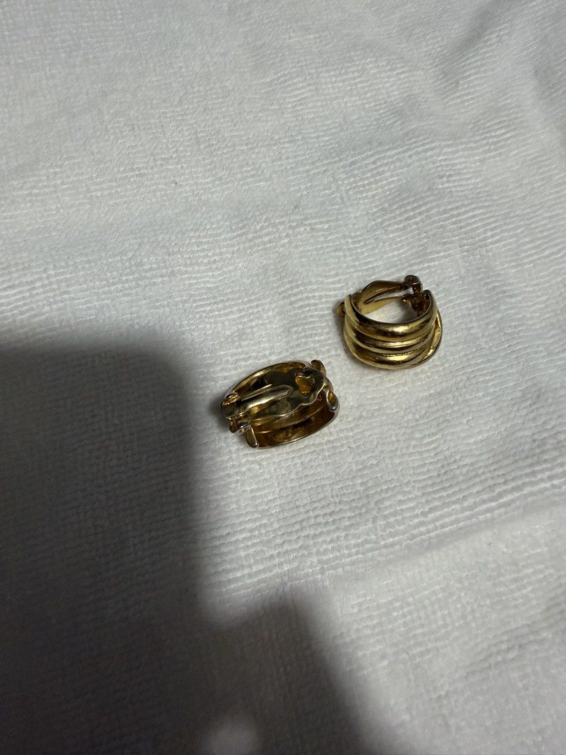 Gold Tone Clip-On Earrings Set (Category: Earrings) located in Digos. Submitted by old_soul. (Listing ID 1464498878, Image 3). Description: - Two pairs of gold tone clip-on earrings - Pair 1: Circular design with a ball accent - Pair 2: Ribbed, curved design - All pieces are clip-on style - Adds a vintage flair to any outfit.