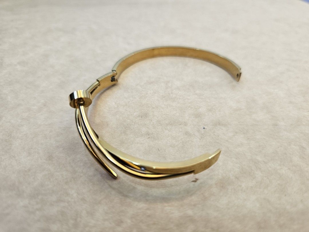 Gold Tone Twisted Bangle Bracelet with Crystals (Category: Bracelets) located in Manila. Submitted by john.tulalian (Listing ID 1464408166, Image 3). Description: -Cartier nail bracelet (inspired) - non-tarnish - Gold tone bangle bracelet - Twisted design with small crystal accents - Hinged clasp closure for easy wear - Classic and versatile piece, perfect for any occasion -Negotiable -Price+Sf.