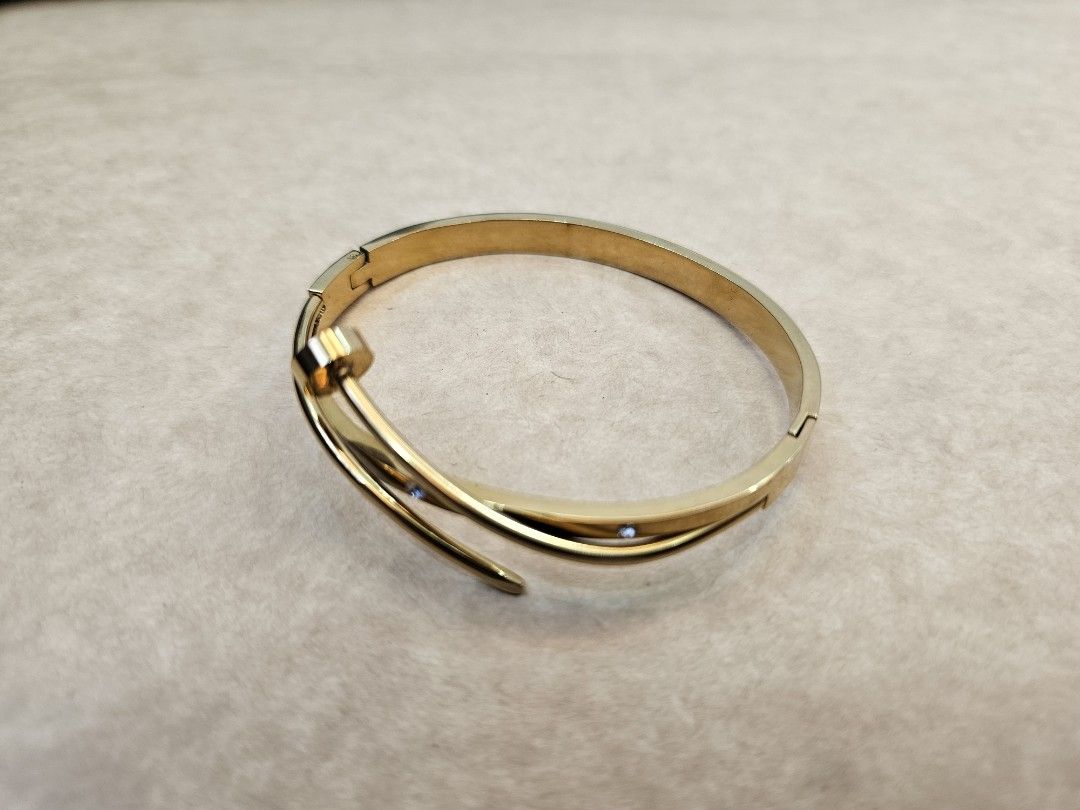 Gold Tone Twisted Bangle Bracelet with Crystals (Category: Bracelets) located in Manila. Submitted by john.tulalian (Listing ID 1464408166, Image 2). Description: -Cartier nail bracelet (inspired) - non-tarnish - Gold tone bangle bracelet - Twisted design with small crystal accents - Hinged clasp closure for easy wear - Classic and versatile piece, perfect for any occasion -Negotiable -Price+Sf.