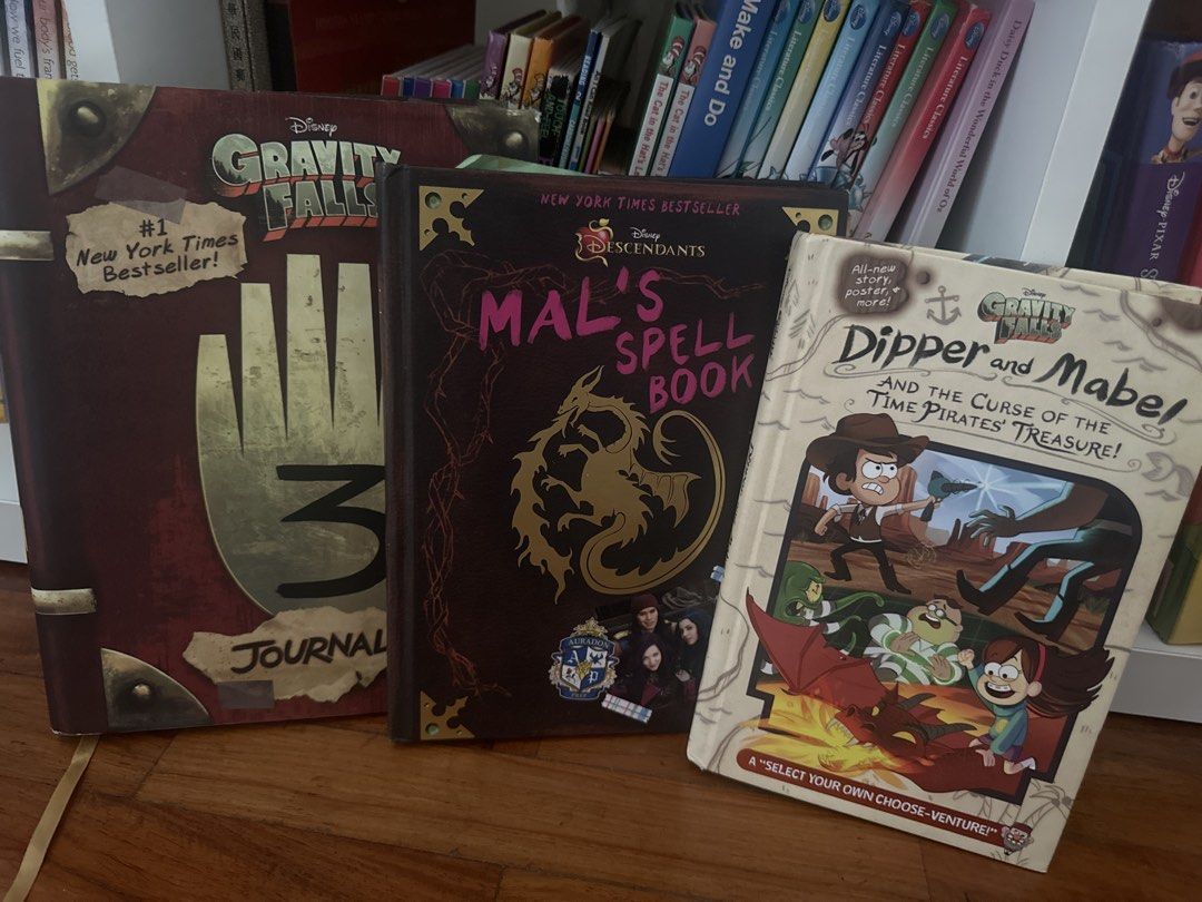 Gravity Falls, Descendants, and Dipper & Mabel Books (Category: Children's Books) located in Manila. Submitted by warmstorm-e55a (Listing ID 1464422909, Image 1). Description: - Bundle includes 3 popular Disney books: - Gravity Falls Journal 3 - Mal's Spell Book (from Descendants) - Dipper & Mabel and the Curse of the Time Pirates' Treasure - All books are in good, pre-loved condition. - Ideal for fans of Gravity Falls and Descendants. - Great gi