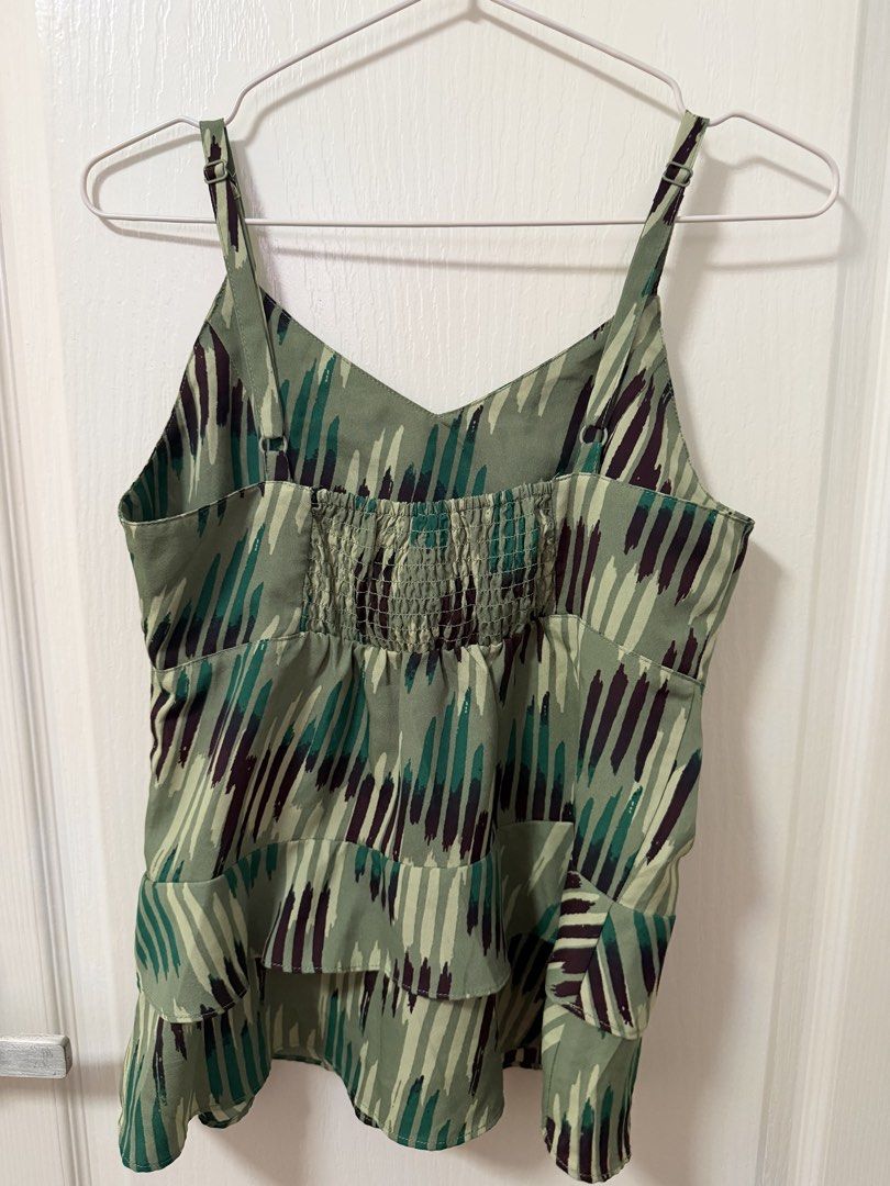 Green Camisole Top with Abstract Print (Category: Sleeveless) located in Cebu City. Submitted by belleskie98 (Listing ID 1464388140, Image 1). Description: - Cute green camisole top - Features an abstract dash print in green and dark purple - Smocked bust detail - Ruffled hemline - Adjustable straps - Great for casual wear or layering.
