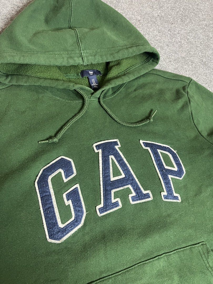 Green GAP Hoodie with Blue Logo (Category: Coats, Jackets and Outerwear) located in Lapu Lapu. Submitted by softfind (Listing ID 1464380732, Image 2). Description: Classic green GAP hoodie with blue/white logo, front pocket, and drawstring hood. Perfect for casual, comfy style. Size: Medium Dimes/inch Width: 22 Length: 27 Condition: 10/10 Color rate: 10/10 Issue: none .