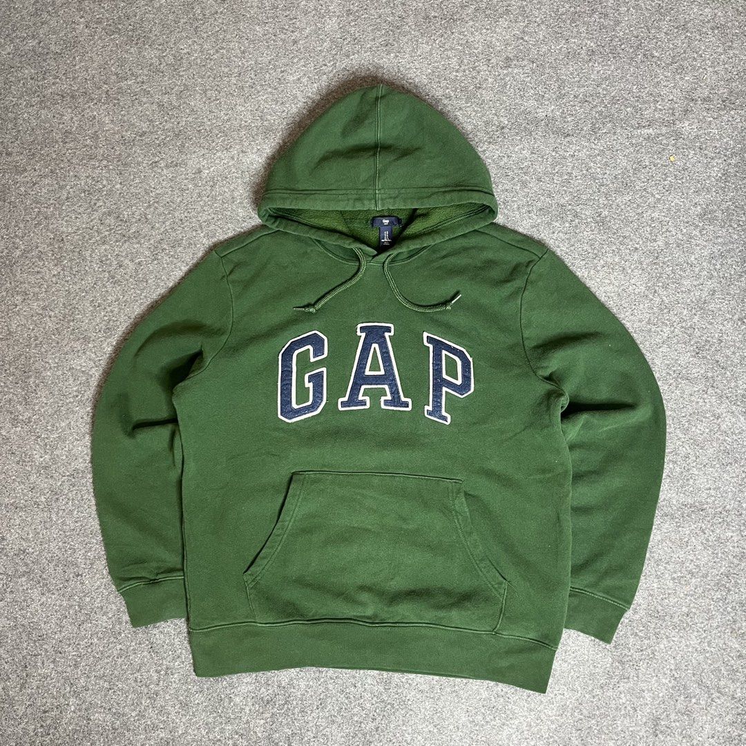 Green GAP Hoodie with Blue Logo (Category: Coats, Jackets and Outerwear) located in Lapu Lapu. Submitted by softfind (Listing ID 1464380732, Image 1). Description: Classic green GAP hoodie with blue/white logo, front pocket, and drawstring hood. Perfect for casual, comfy style. Size: Medium Dimes/inch Width: 22 Length: 27 Condition: 10/10 Color rate: 10/10 Issue: none .