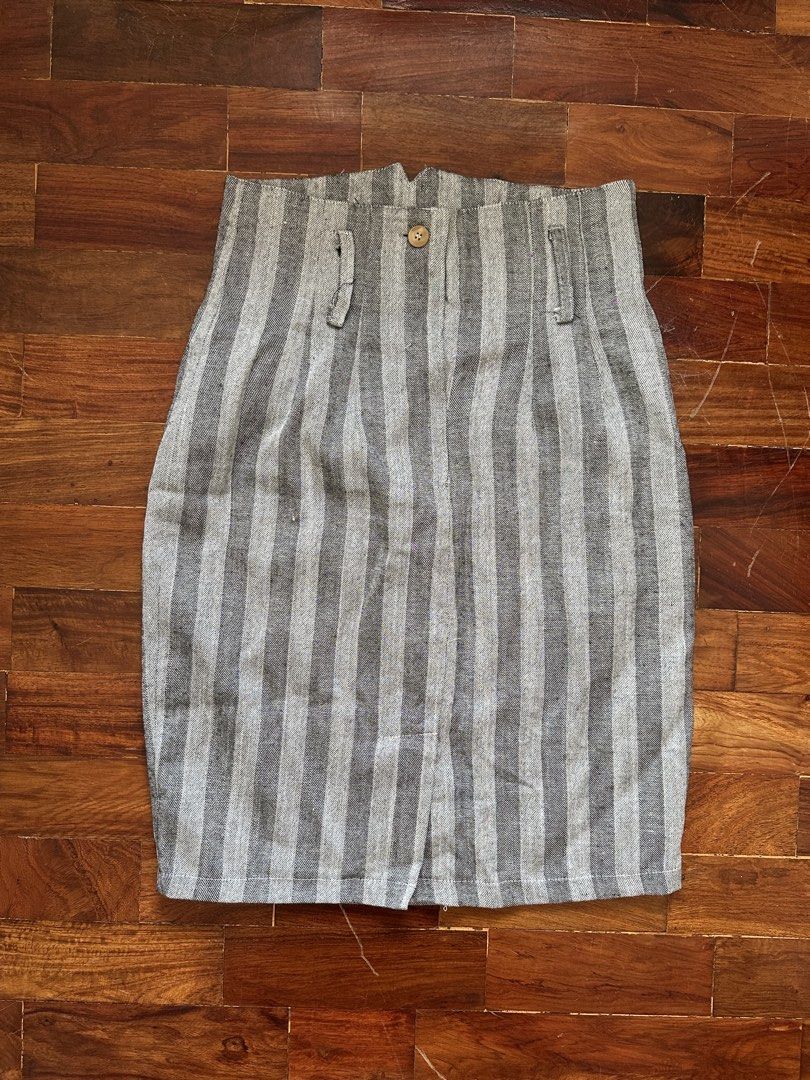 Grey Striped High-Waisted Skirt (Category: Skirts) located in Cainta. Submitted by buy.preloved (Listing ID 1464375523, Image 1). Description: - Grey and white striped skirt - High-waisted design - Front button closure - Two small side pockets - Pencil skirt style - Versatile for casual or work outfits.
