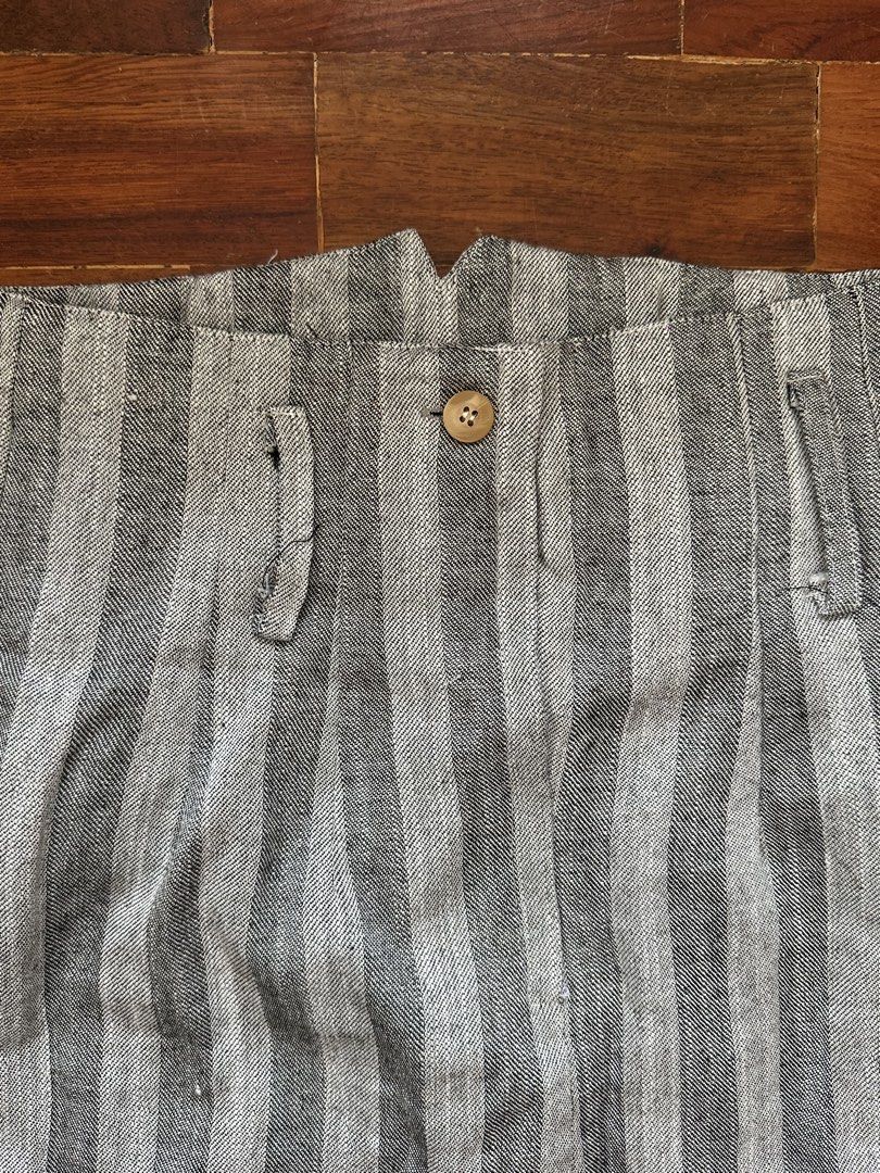 Grey Striped High-Waisted Skirt (Category: Skirts) located in Cainta. Submitted by buy.preloved (Listing ID 1464375523, Image 2). Description: - Grey and white striped skirt - High-waisted design - Front button closure - Two small side pockets - Pencil skirt style - Versatile for casual or work outfits.
