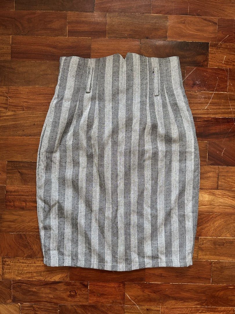 Grey Striped High-Waisted Skirt (Category: Skirts) located in Cainta. Submitted by buy.preloved (Listing ID 1464375523, Image 3). Description: - Grey and white striped skirt - High-waisted design - Front button closure - Two small side pockets - Pencil skirt style - Versatile for casual or work outfits.