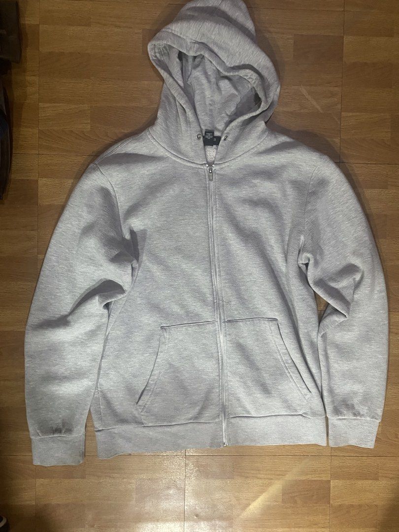 Grey Zip-Up Hoodie (Category: Coats, Jackets and Outerwear) located in Mandaluyong City. Submitted by gabb_bautista (Listing ID 1464473304, Image 1). Description: - Classic grey zip-up hoodie - Features a convenient front pocket - Includes a comfortable hood - Ideal for layering or casual outfits - Versatile and easy to pair with any bottoms.