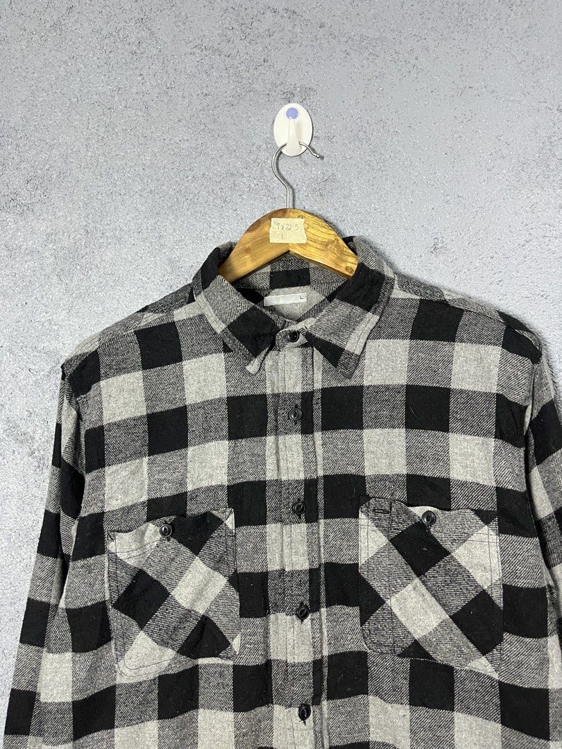 GU Flannel Checkered Shirt Size L (Category: Tshirts & Polo Shirts ) located in Famy. Submitted by basicthrifted (Listing ID 1464530264, Image 2). Description: - Classic black and grey checkered flannel shirt from Uniqlo. - Features two chest pockets with button closure. - Full button-up front. - Made from a comfortable polyester and rayon blend. - Versatile for layering or wearing as a standalone piece..