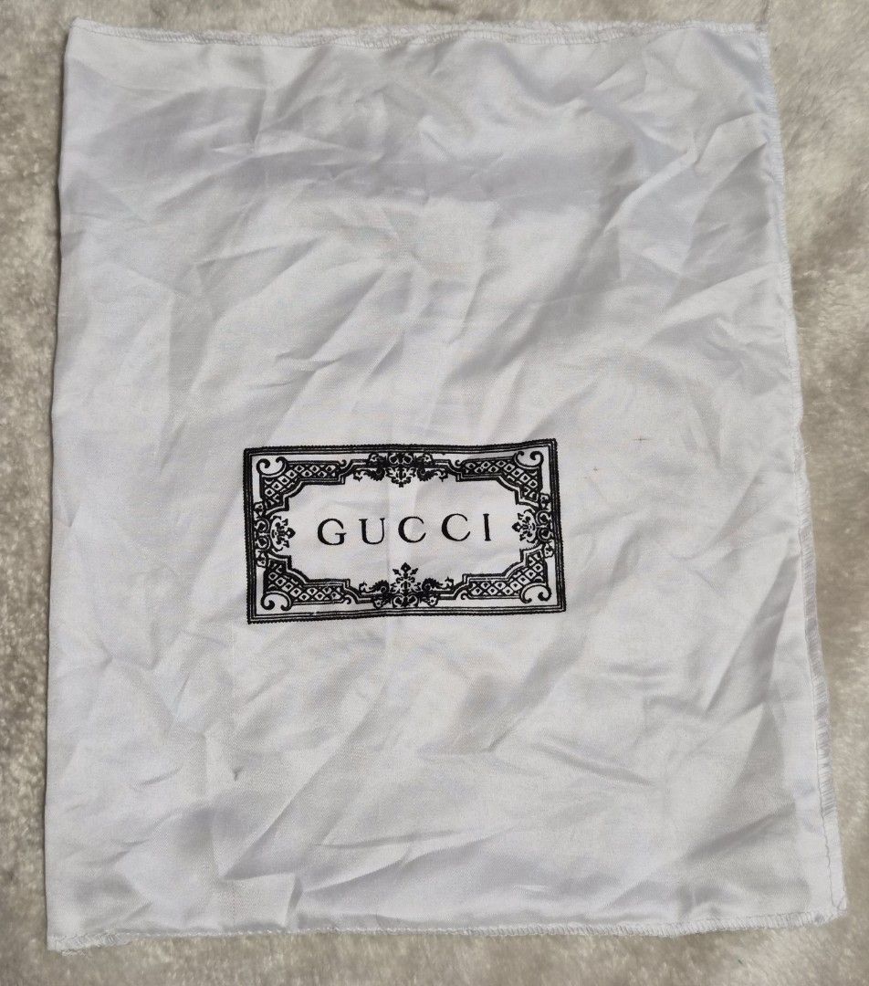 Gucci Dust Bag 13×11 inches (Category: Luxury Bags & Wallets) located in Mandaue City. Submitted by chuchi152615 (Listing ID 1464404462, Image 3). Description: - Gucci dust bag - White fabric with black Gucci logo - Ideal for storing handbags or shoes - Protects your valuables - Approximate dimensions: 13" x 16" - Clean and ready for use.