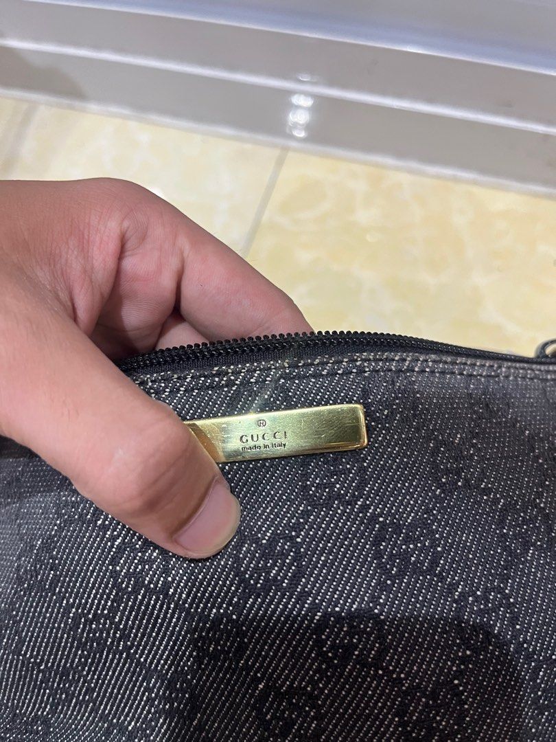 Gucci GG Monogram Denim Pouch Bag (Category: Luxury Bags & Wallets) located in Caloocan City. Submitted by pumarenluc79160 (Listing ID 1464392858, Image 2). Description: - Authentic Gucci pouch bag - Classic GG monogram pattern on denim - Gold tone hardware - Zipper closure - Made in Italy - Interior Gucci leather tag with serial number 0719c 2123 - Ideal for carrying essentials.