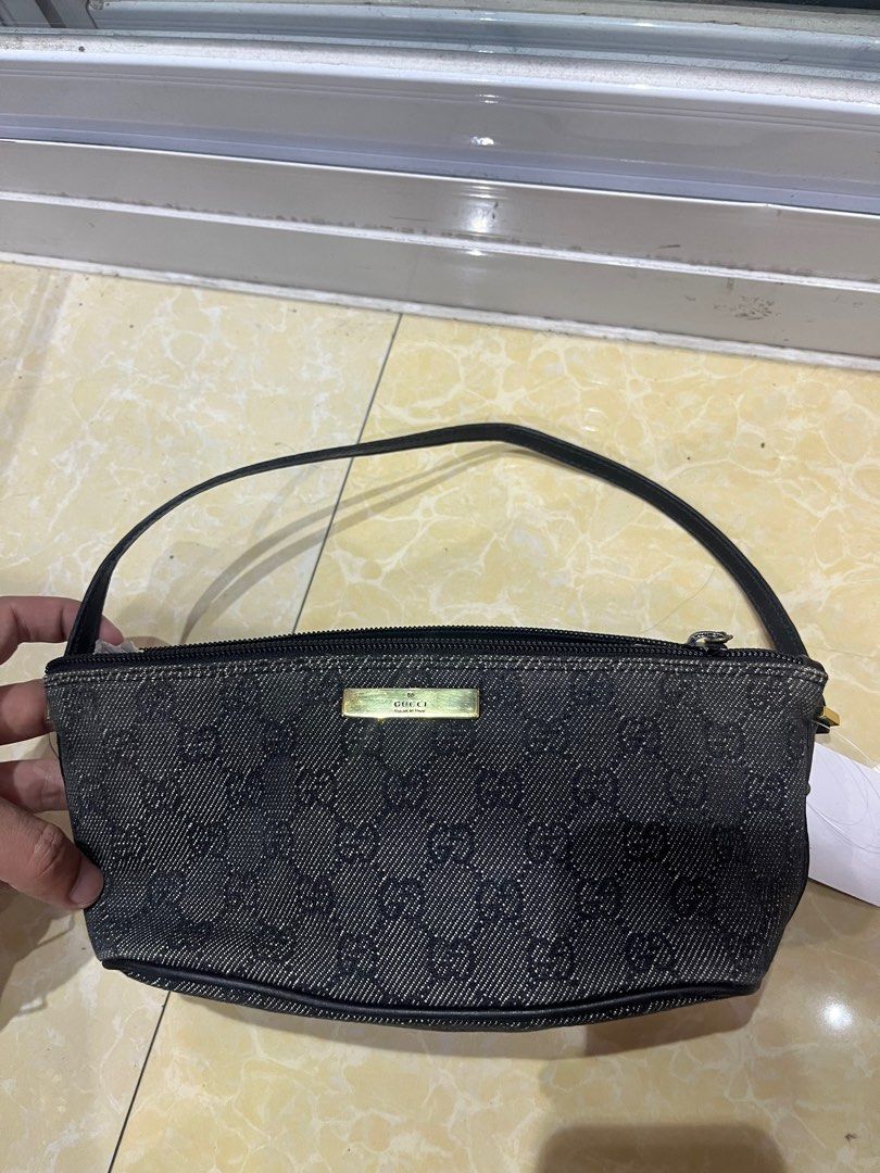 Gucci GG Monogram Denim Pouch Bag (Category: Luxury Bags & Wallets) located in Caloocan City. Submitted by pumarenluc79160 (Listing ID 1464392858, Image 1). Description: - Authentic Gucci pouch bag - Classic GG monogram pattern on denim - Gold tone hardware - Zipper closure - Made in Italy - Interior Gucci leather tag with serial number 0719c 2123 - Ideal for carrying essentials.