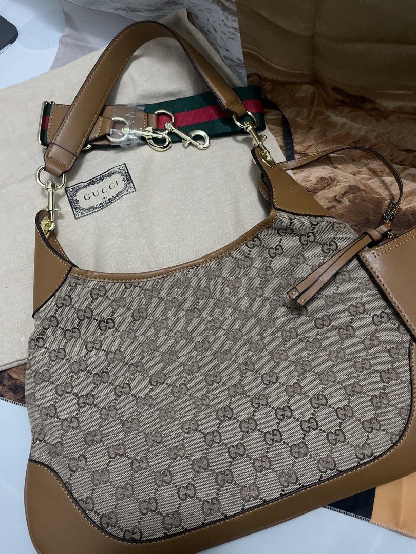 Gucci Monogram Canvas Shoulder Bag with Pouch (Category: Luxury Bags & Wallets) located in Cagayan de Oro. Submitted by luxieebags (Listing ID 1464547584, Image 3). Description: - Authentic Gucci shoulder bag - Classic GG monogram canvas - Tan leather trim - Comes with matching leather pouch - Includes green and red stripe strap - Gold hardware details - Perfect for everyday use - Please check photos for detailed condition.