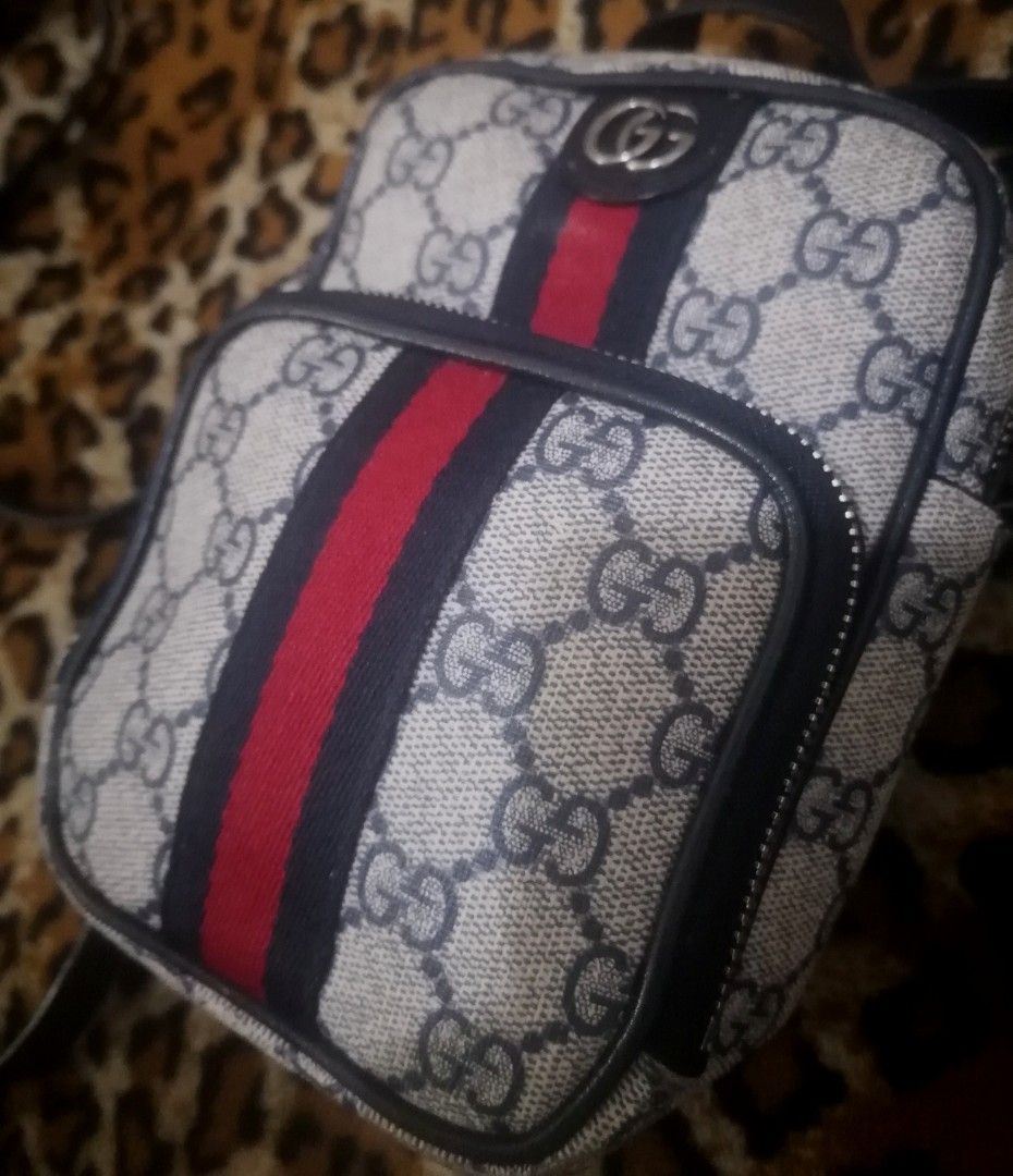 Gucci Ophidia GG Supreme Mini Bag (Category: Luxury Bags & Wallets) located in Cebu City. Submitted by roadthrift (Listing ID 1464385059, Image 2). Description: - Authentic Gucci mini crossbody bag - Classic GG monogram canvas - Signature red and blue web stripe - Secure zipper closure - Adjustable strap for comfortable wear - Small top handle for versatility - Ideal size for carrying essentials.