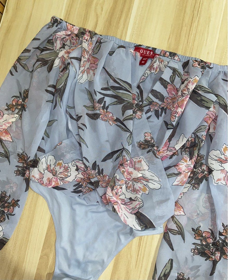 GUESS Authentic Off- Shoulder Floral Bodysuit (Category: Bikinis & Swimsuits) located in Guinobatan. Submitted by jadieee_young22 (Listing ID 1464409656, Image 1). Description: - never used - quality still very nice! - 100% authentic! with Guess tag - bought from canada 🇨🇦 - fits XS as seen in the 2nd picture - long sleeves, draped chiffon wrap front - adjustable 3-snap closure at the bottom for easy wear - color: light blue- floral - check the