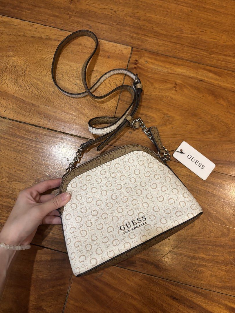 Guess Monogram Crossbody Bag (Category: Cross-body Bags) located in Manila. Submitted by zephaniah79 (Listing ID 1464556880, Image 1). Description: - Classic Guess crossbody bag - All-over G logo print in beige and brown - Adjustable strap with chain detail - Comes with original tag - Ideal for everyday use.